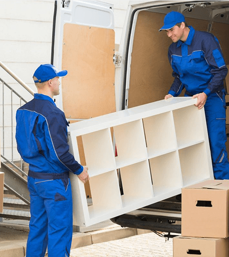 Young Male Movers Unloading Furniture and Cardboard Boxes From Truck on Street