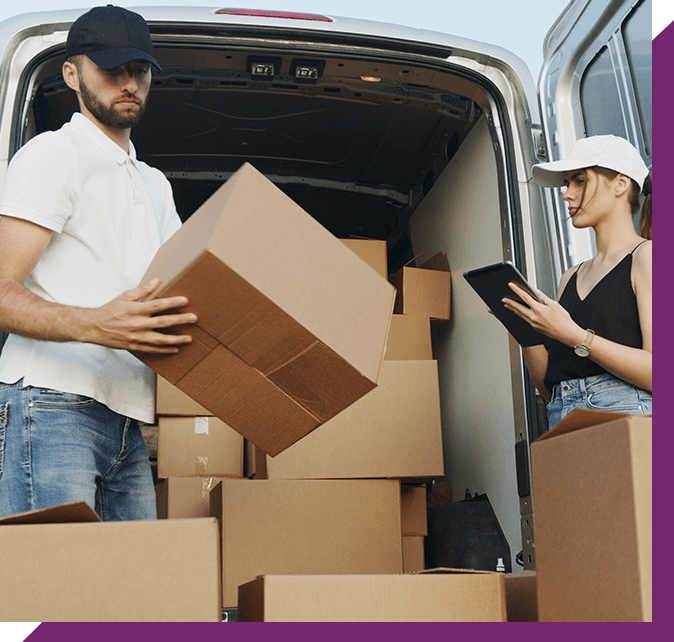 Couple Moving Boxes From Van or Truck Together Outdoors